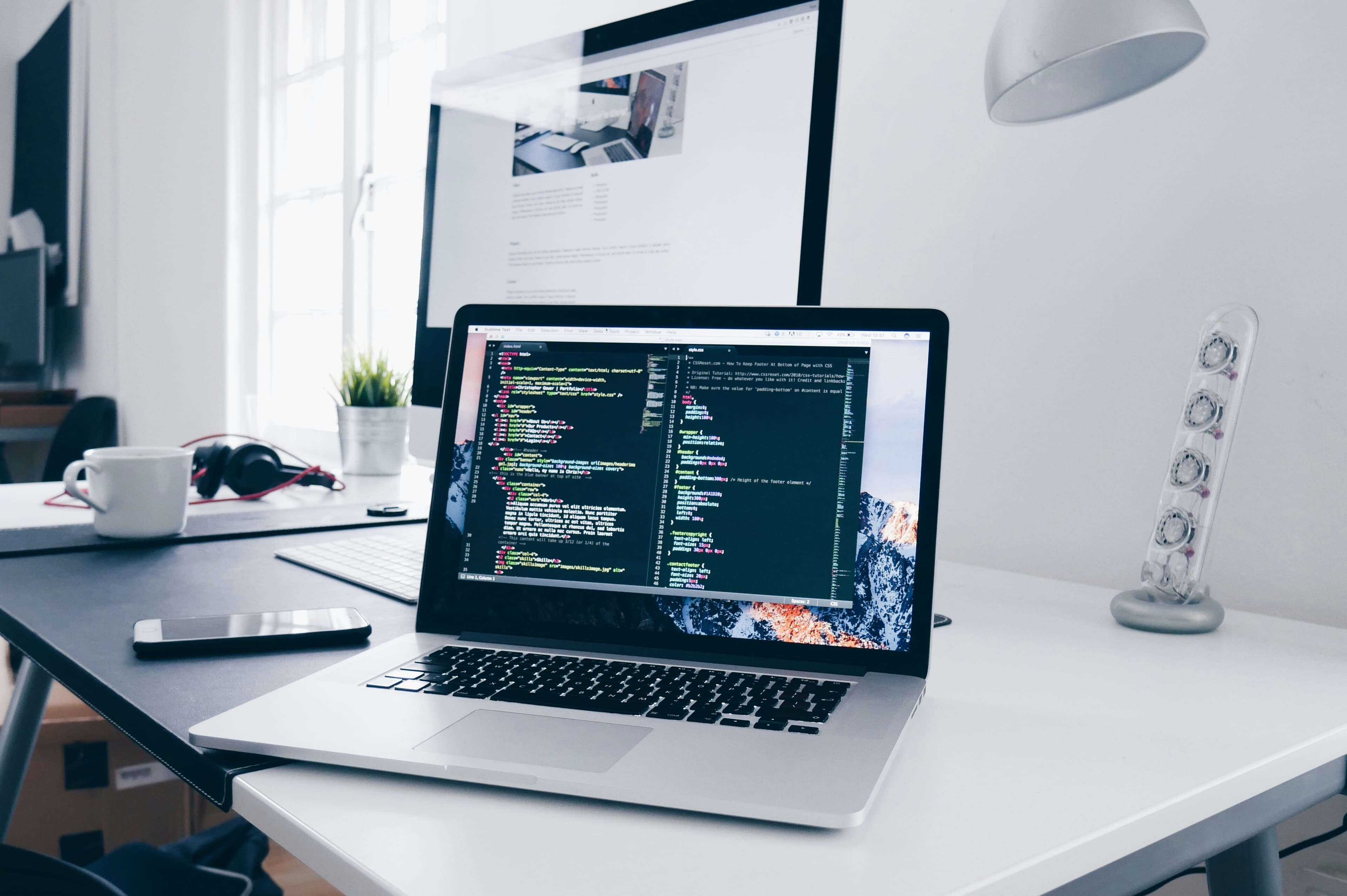 Business page — laptop with code